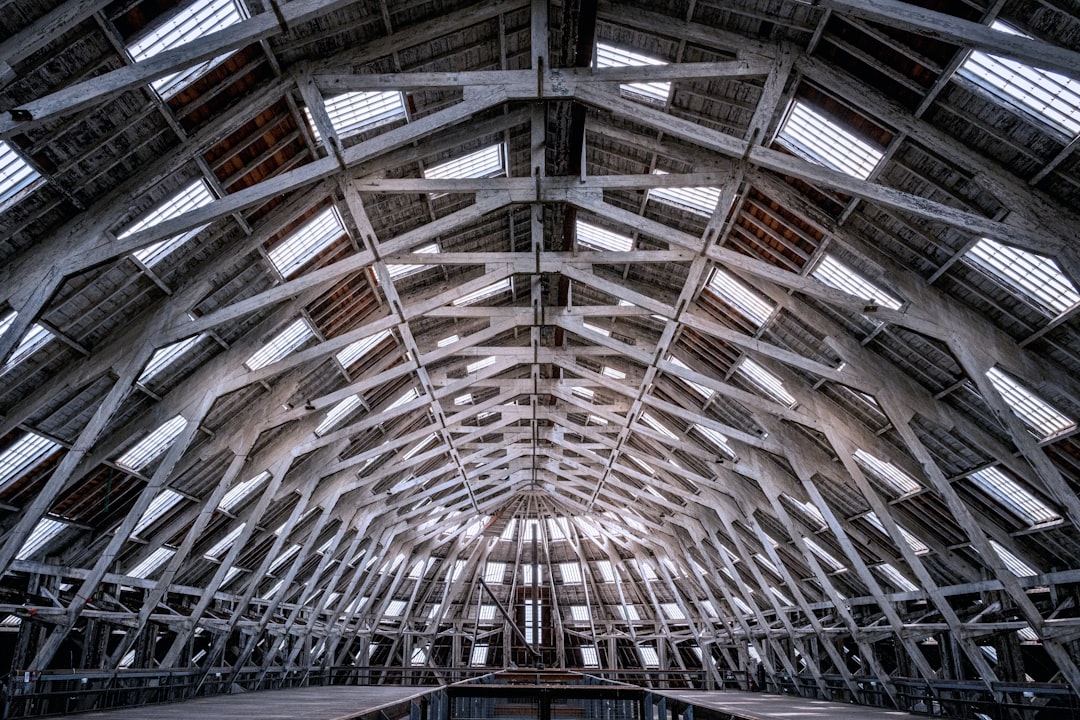 The inside of a building with a roof made of metal beams