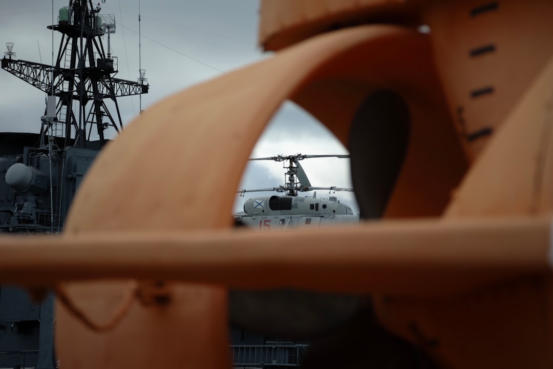 Helicopter seen through ship's propeller