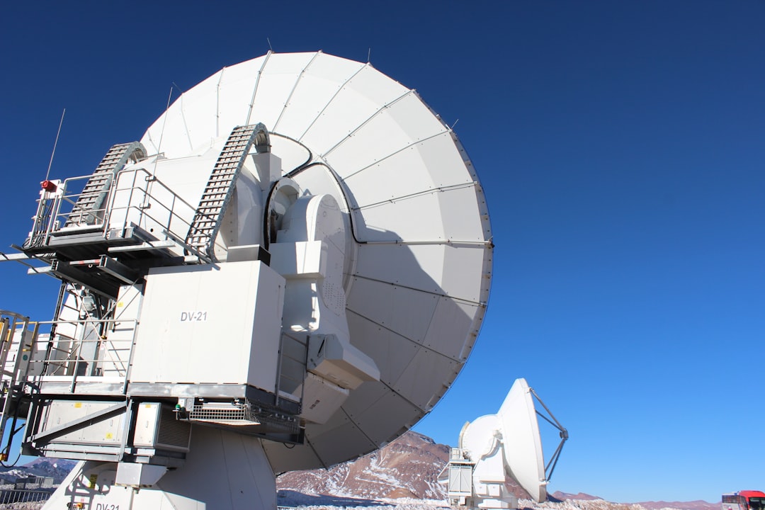 a large satellite dish sitting on top of a snow covered ground
