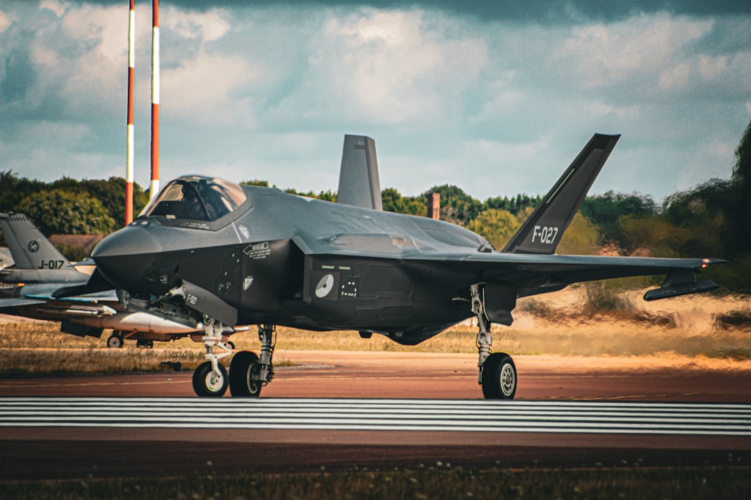 a fighter jet sitting on top of an airport runway